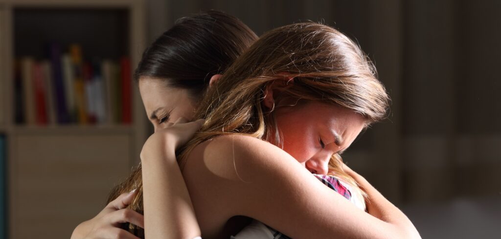 Mom helping daughter after learning what triggers an eating disorder relapse